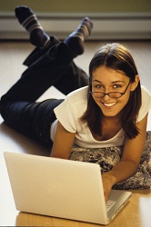 woman with laptop reading Tips for Starting Homeschooling