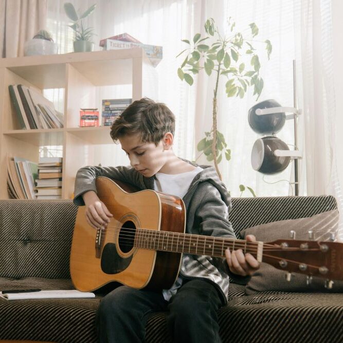 high school homeschool boy playing guitar