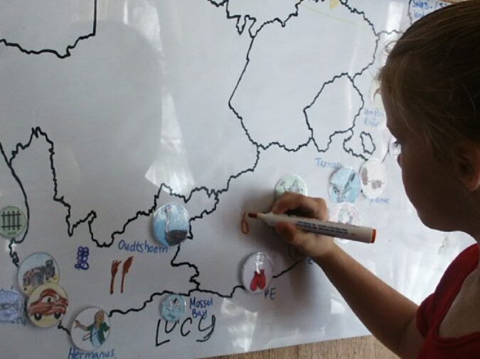 A child creating a personalised South African map in a Charlotte Mason homeschool